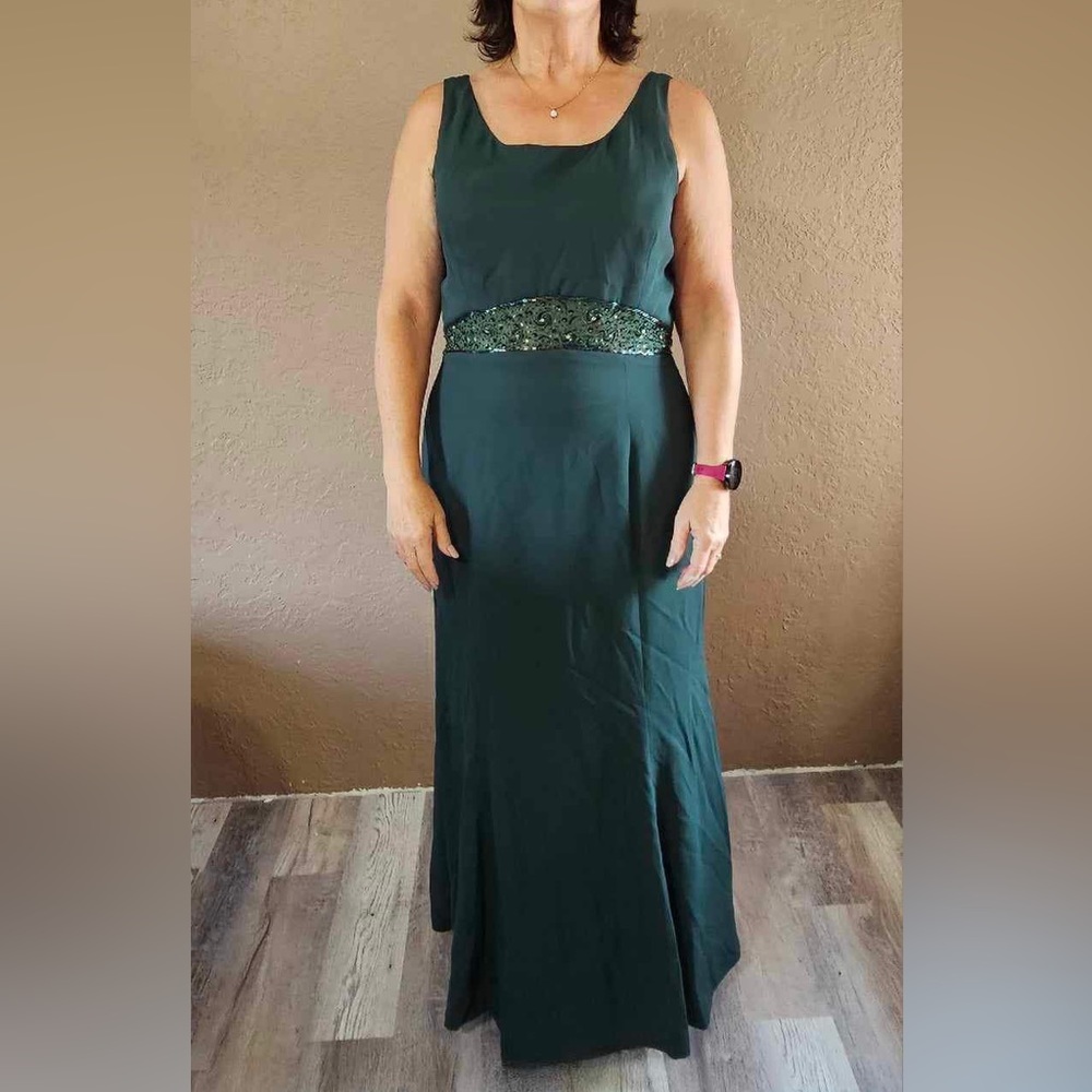 Gorgeous floor length emerald green gown with beautiful beadwork on the waist.
